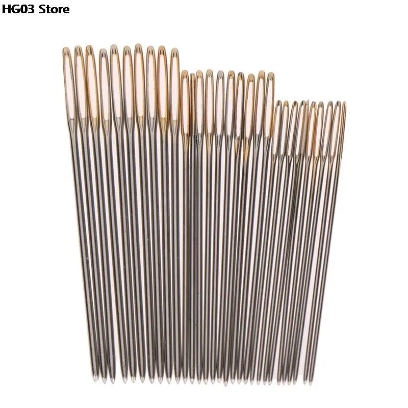 A set of fine gold-colored embroidery and hand sewing needles arranged vertically.