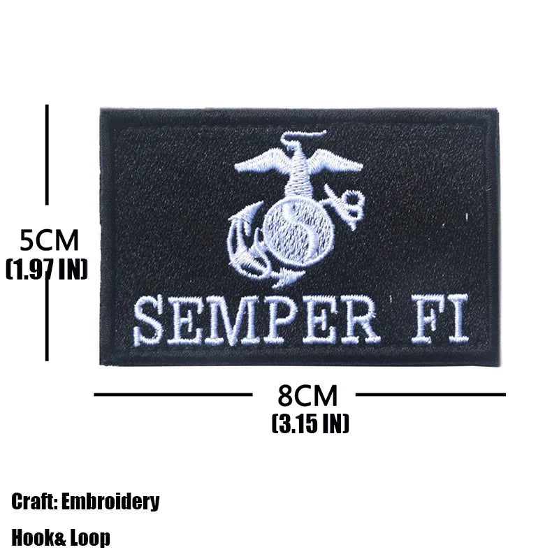 Black embroidered patch featuring a silver trident emblem and the text SEMPER FI
