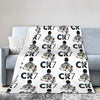 A white throw blanket featuring a repeating pattern of soccer players wearing jerseys and the text CR7.