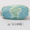 A ball of hand-dyed fabric strip yarn featuring a soft blue and green watercolor pattern for crochet and knitting.