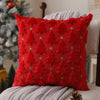 A vibrant red knitted cushion cover with a textured pattern of small green star appliqués.