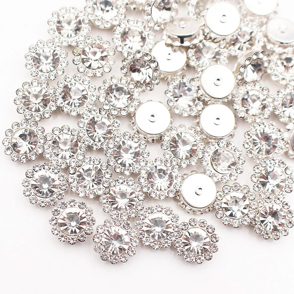 A close-up of silver crystal rhinestone sew-on buttons arranged in a sunflower pattern.