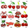 A collection of embroidered fruit patches featuring various fruits like cherries, apples, and berries.