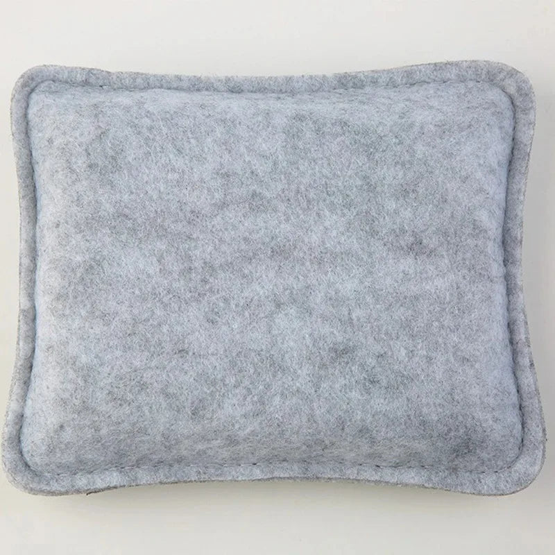 A square, gray needle felting mat pad with rounded edges.
