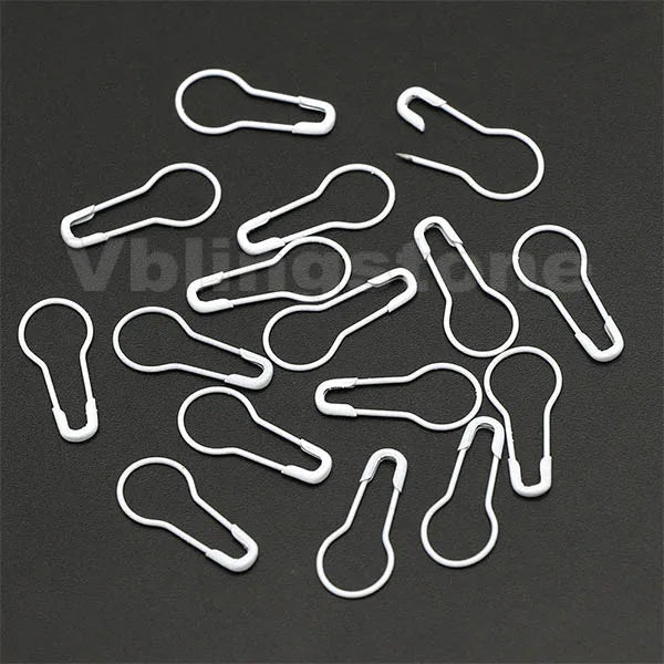 A collection of white gourd-shaped locking safety pins for knitting and sewing.
