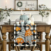 Autumn plaid table runner featuring a pumpkin dwarf design on a wooden table.
