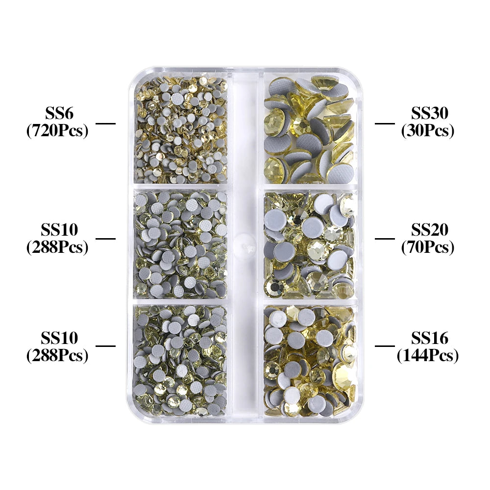 A clear plastic container filled with various sizes of gold and silver glass rhinestones for crafting.