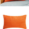 Orange ribbed corduroy cushion covers with a textured, striped pattern