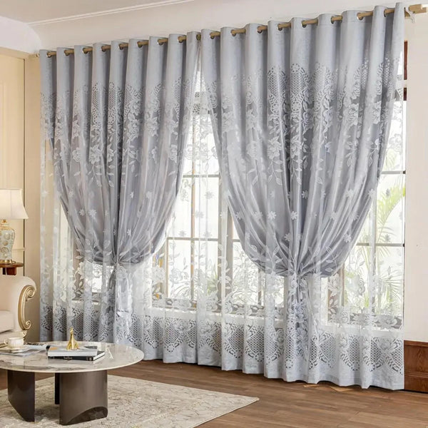 Light gray vintage floral blackout curtains hanging in a window with sheer white undercurtains