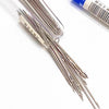 A collection of precision stainless steel sewing needles is shown on a white background.