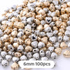 A mix of gold and silver heart-shaped geometric acrylic beads for jewelry making