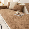 A brown plush sofa cushion cover with textured fabric and decorative pillows on a light-colored sofa.