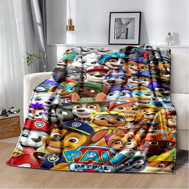 A colorful Paw Patrol themed flannel throw blanket featuring various cartoon dog characters.