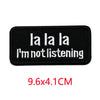 Black iron-on embroidered letter patch with white text that reads I'm not listening