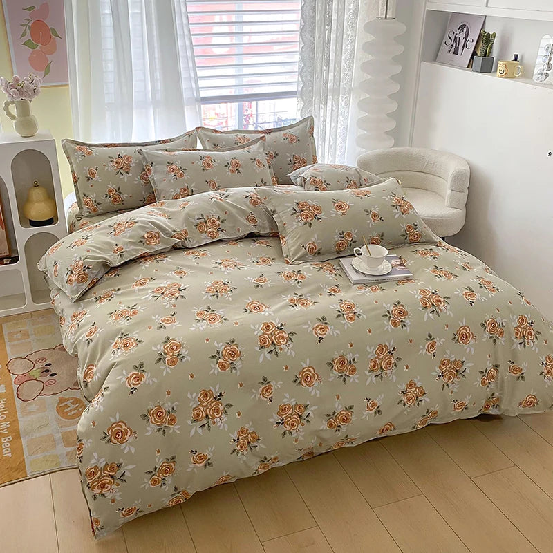 A beige floral printed duvet cover set with two pillowcases displayed on a bed in a bright room.