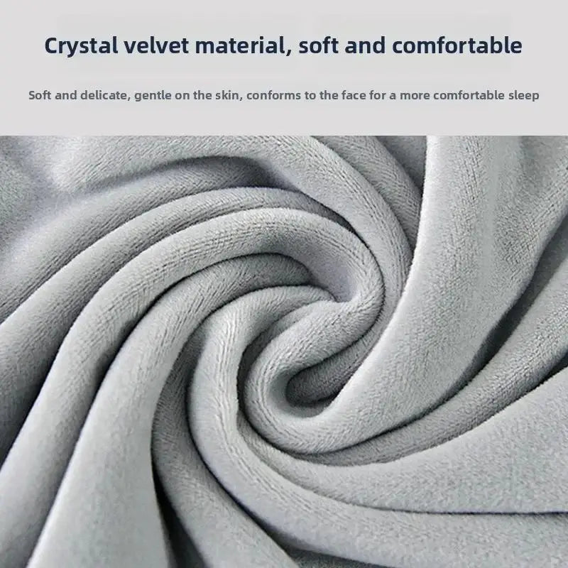 Close-up of a soft, gray velvet fabric forming a swirling pattern for a travel neck pillow.