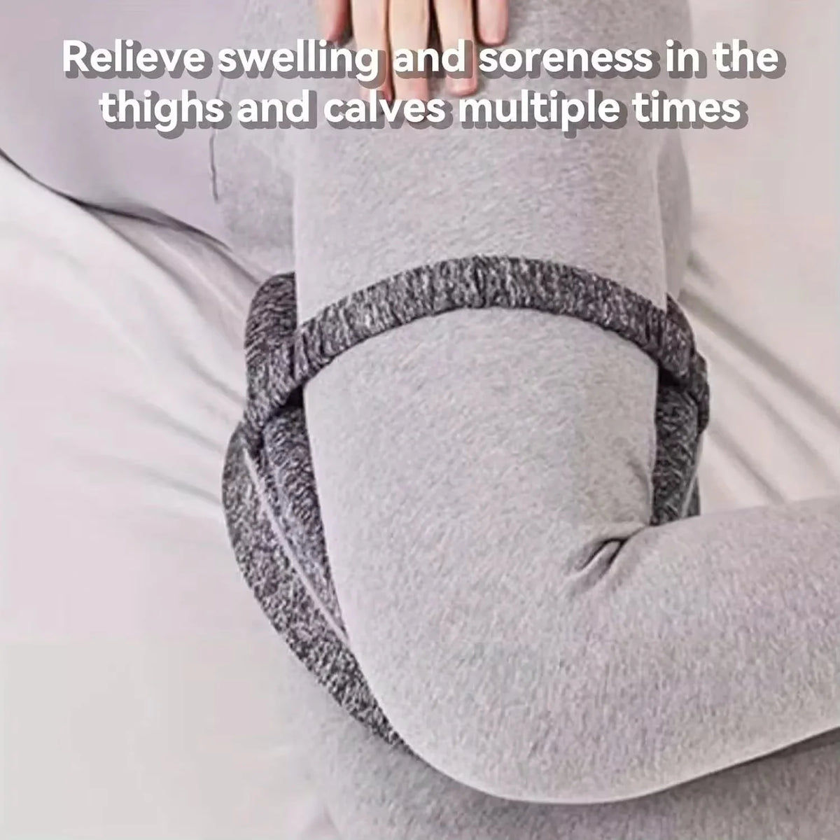 A person is using a gray memory foam knee pillow for relief of swelling and soreness in the thighs and calves.