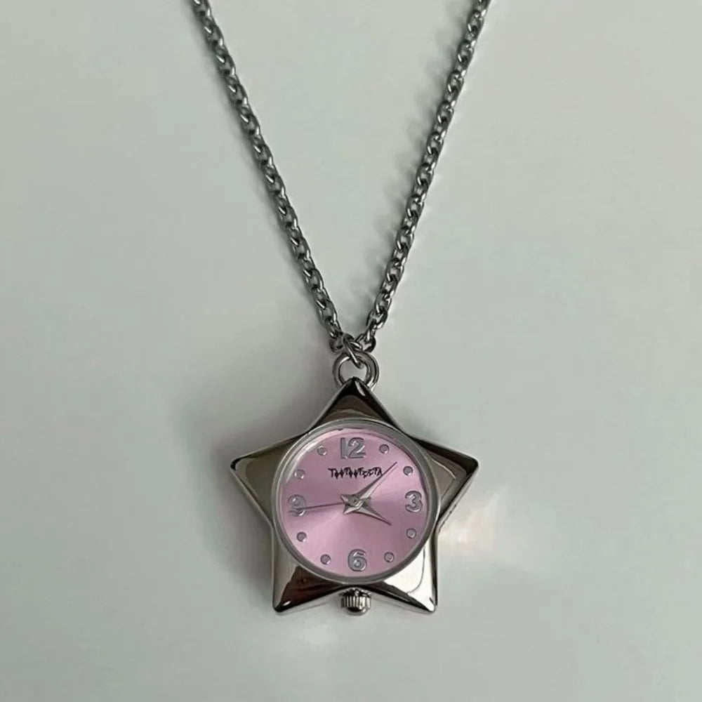 Silver chain necklace with a pink-faced star-shaped pocket watch charm.