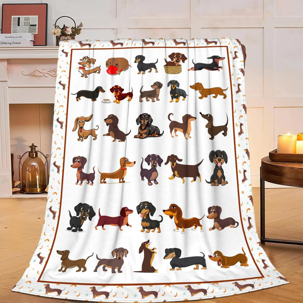 A white fabric blanket featuring a pattern of various dog breeds in brown and black colors.