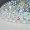 A close-up of multi-size shiny AB crystal glass beads used for jewelry making
