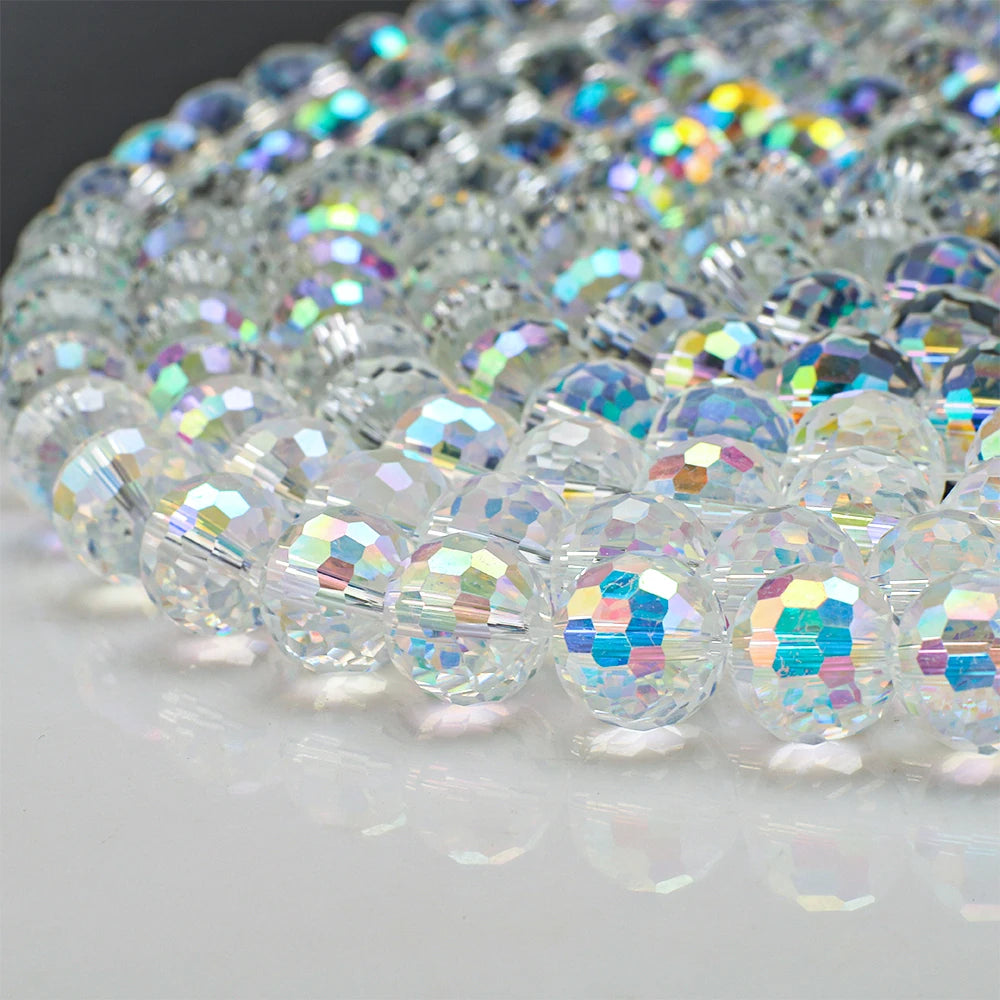 A close-up of multi-size shiny AB crystal glass beads used for jewelry making