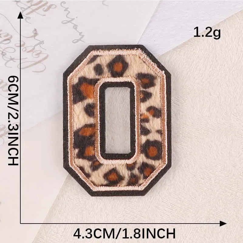 A leopard print iron-on alphabet patch shaped like the letter O, measuring 1.2g and 4.3cm wide.