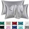 A collection of silky satin pillowcases in various shades including silver, green, pink, and blue.
