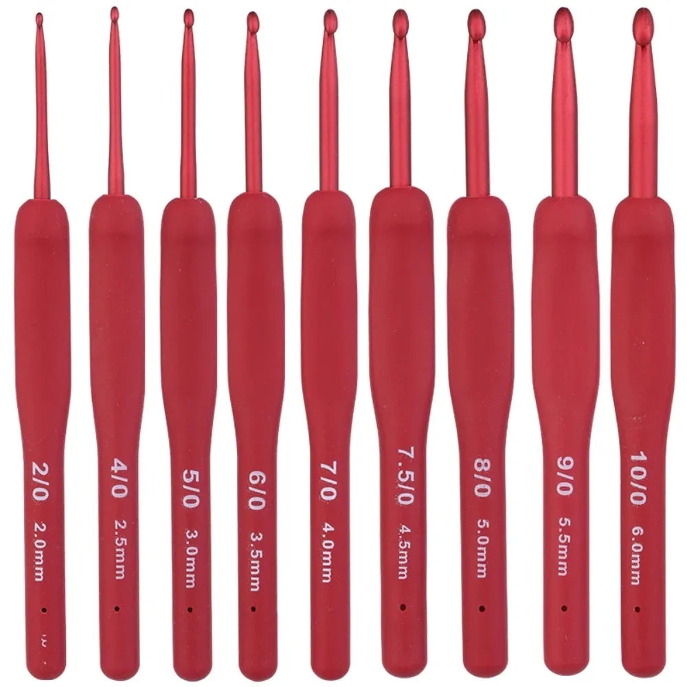 A row of red ergonomic crochet hooks with various sizes and tips displayed vertically.