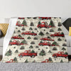 A patterned throw blanket featuring vintage red pickup trucks and evergreen trees on a light background.
