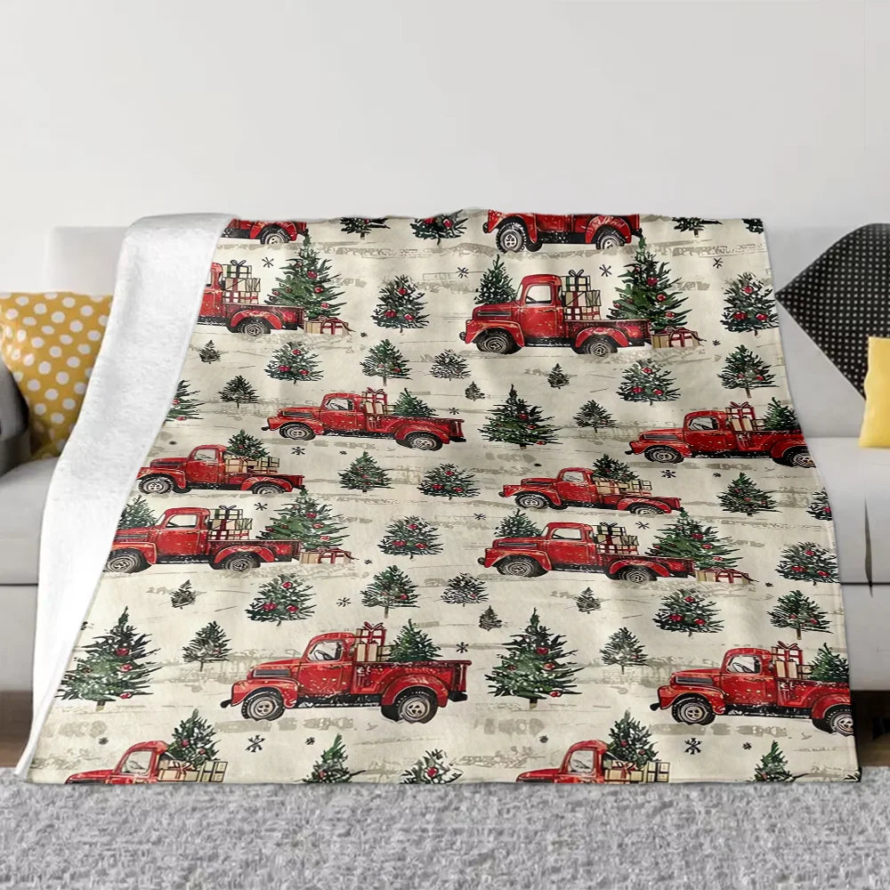 A patterned throw blanket featuring vintage red pickup trucks and evergreen trees on a light background.