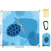 A blue and teal patterned foldable waterproof outdoor picnic mat with a sea turtle design and accessories.