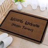 A brown entrance mat with the text Wizards Welcome Muggles Tolerated printed on it.
