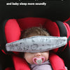 A baby is sleeping in an adjustable car seat with a head support pillow covering his eyes.
