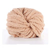 A ball of light beige hand-woven chunky chenille yarn