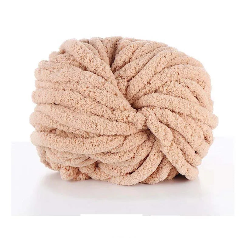 A ball of light beige hand-woven chunky chenille yarn