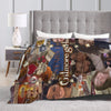 A cozy knit throw blanket featuring a collage of faces and text on a bed.