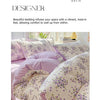A close-up of floral printed lavender bedding set featuring purple and green botanical patterns.