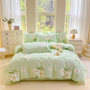 A light green cotton duvet cover and pillow set displayed on a bed with white curtains and natural light.