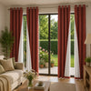 Four panels of linen textured blackout curtains in deep red and white hang over glass doors.