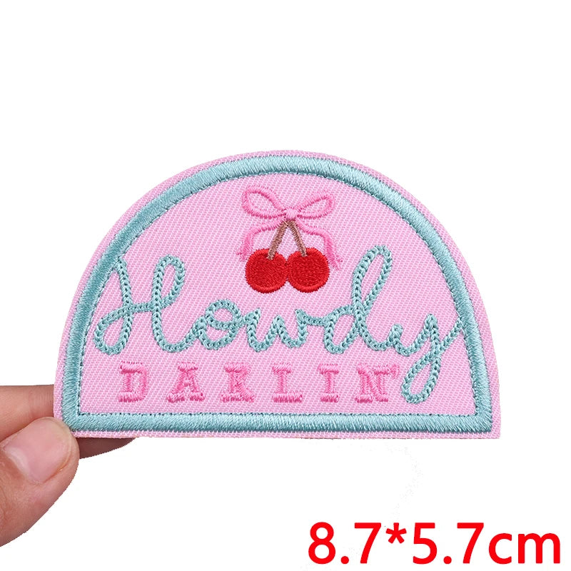 Pink embroidered patch with the text Howdy Darling