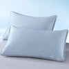 Light blue quilted bean pillow cover resting on a white surface.