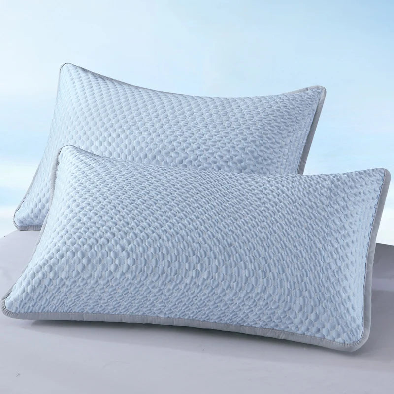 Light blue quilted bean pillow cover resting on a white surface.