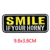Black and yellow embroidered patch with the text SMILE IF YOUR HORNY