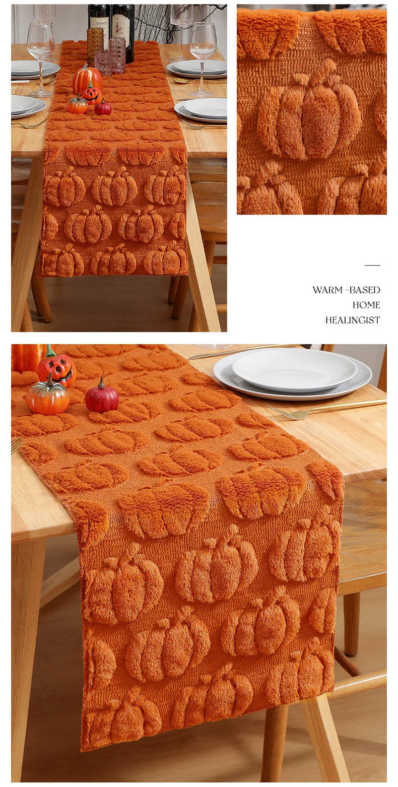 Orange felt table runner with pumpkin embroidery used as a festive Halloween decoration.