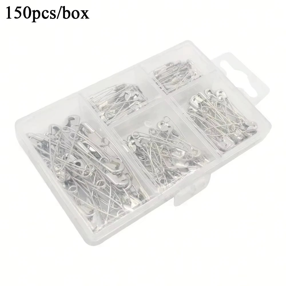 A clear plastic box containing 150 stainless steel safety pins assorted sizes.
