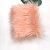 A fluffy, light peach colored faux fur plush fabric for sewing and crafting.