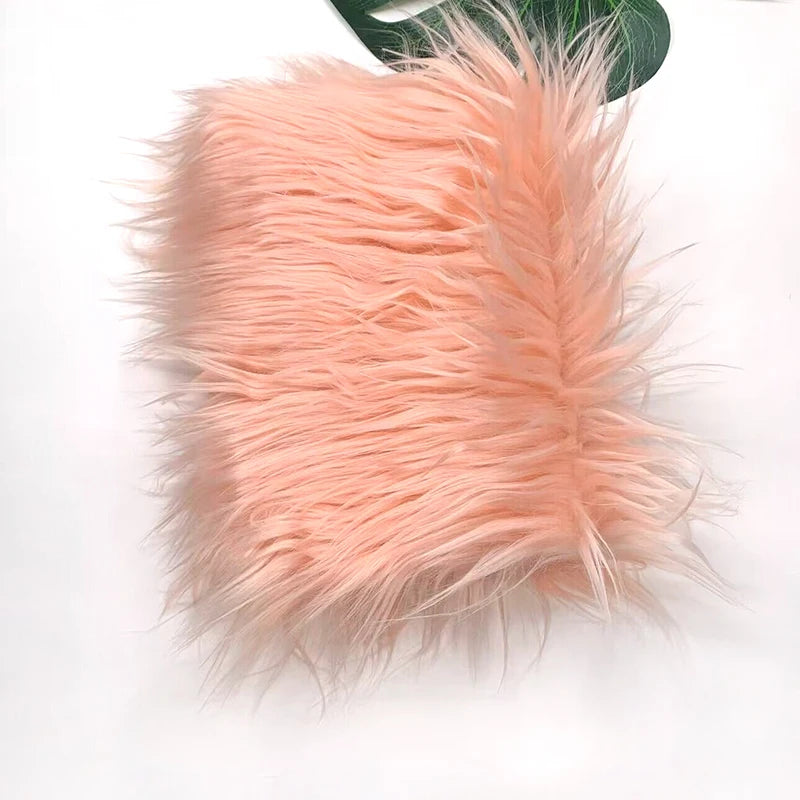 A fluffy, light peach colored faux fur plush fabric for sewing and crafting.