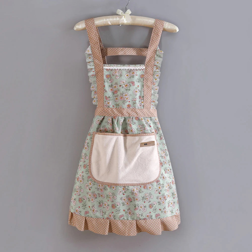 A floral pattern kitchen apron with adjustable straps and a pink pocket displayed on a wooden hanger.
