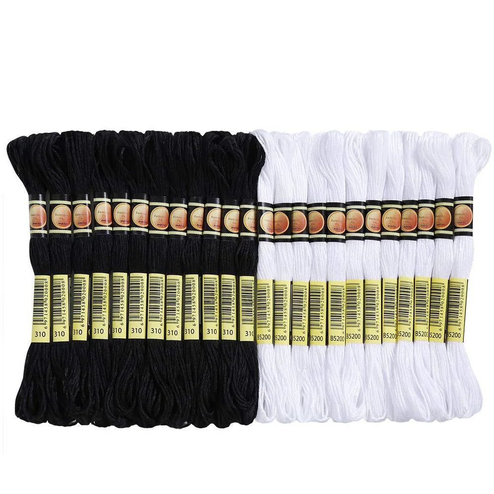 A set of white and black embroidery floss threads bundled together for crafting