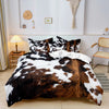 A cow print duvet cover set featuring brown and black patches on a white background displayed on a bed.